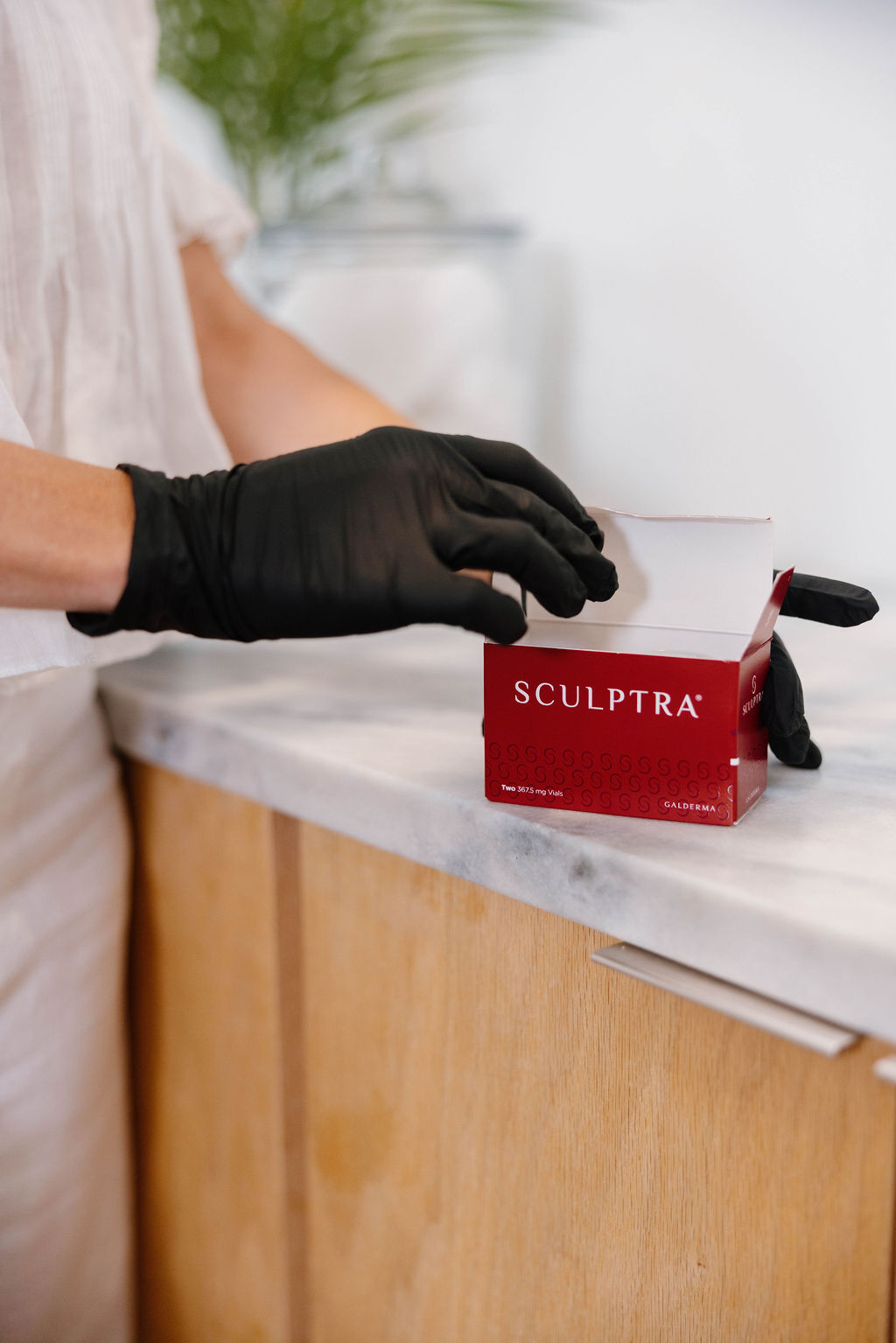 Gloved hands opening clinical product packaging